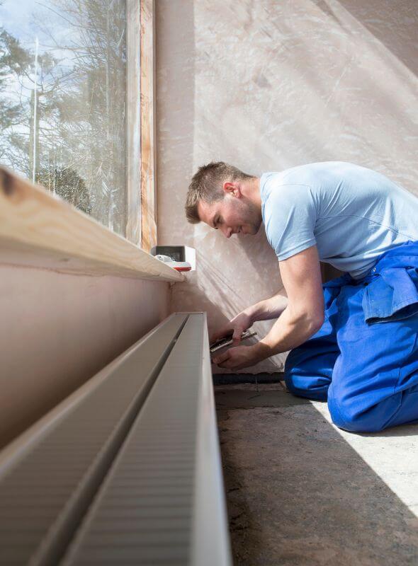 handyman in Worcester working on heating duct