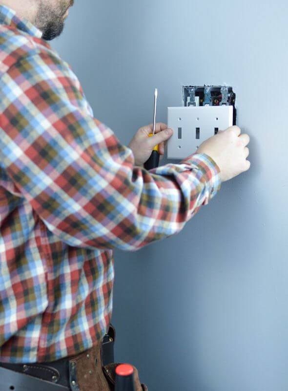 handyman installing wall light switch in Worcester